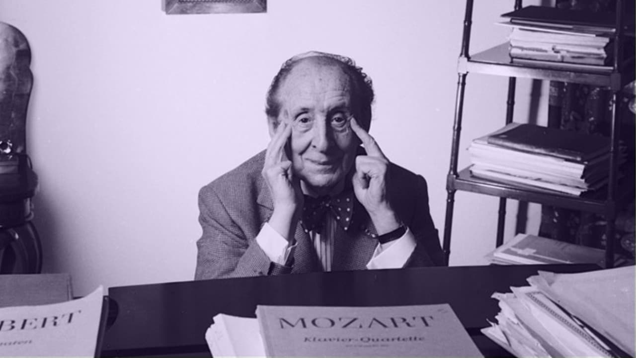 Old Vladimir Horowitz sitting behind the piano looking over his Mozart Score